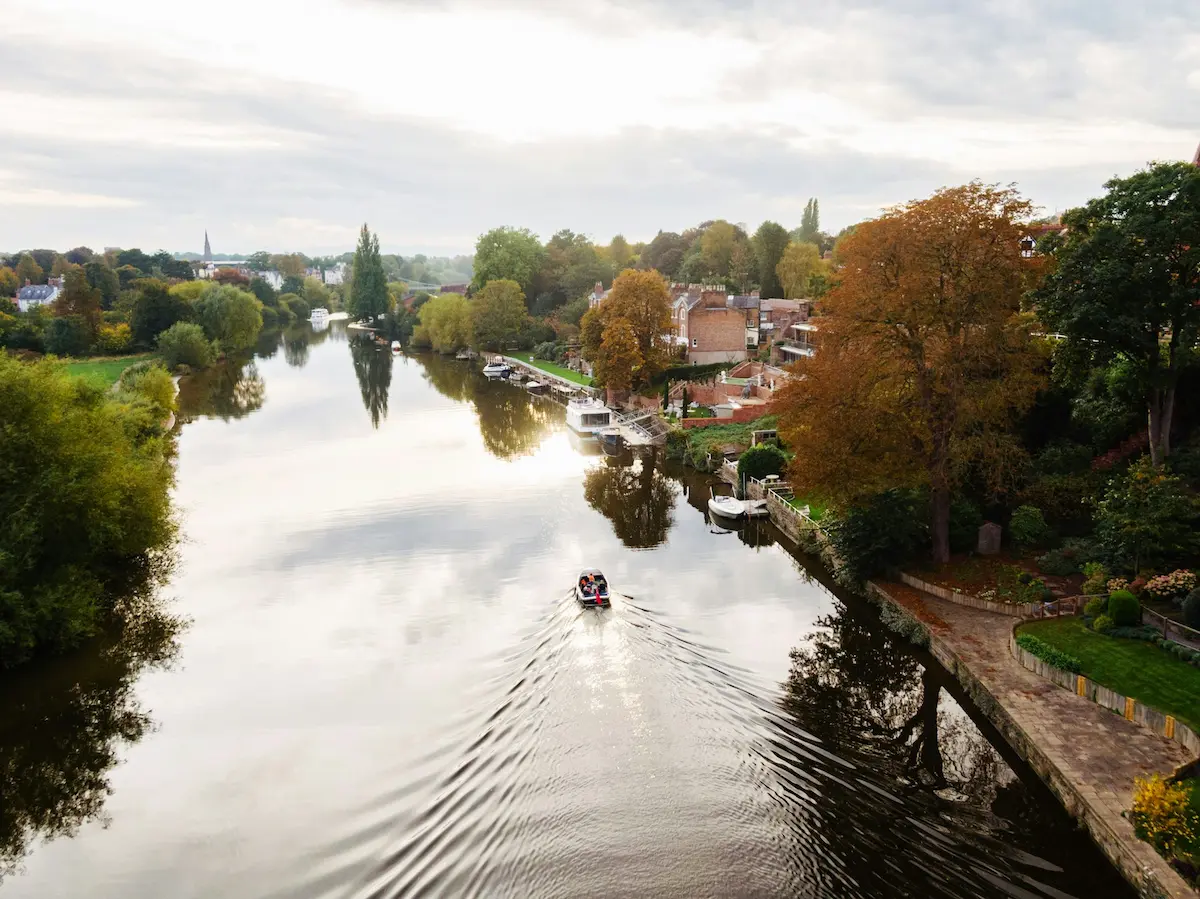 A boat going down a river in Chester, Cheshire.